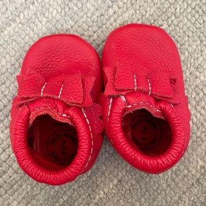 freshly picked baby moccasin size 2. red bow.